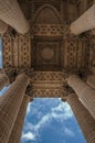 Odd perspective of columns at the Pantheon entrance in neoclassical style and cloudy sky in Paris. Royalty Free Stock Photo